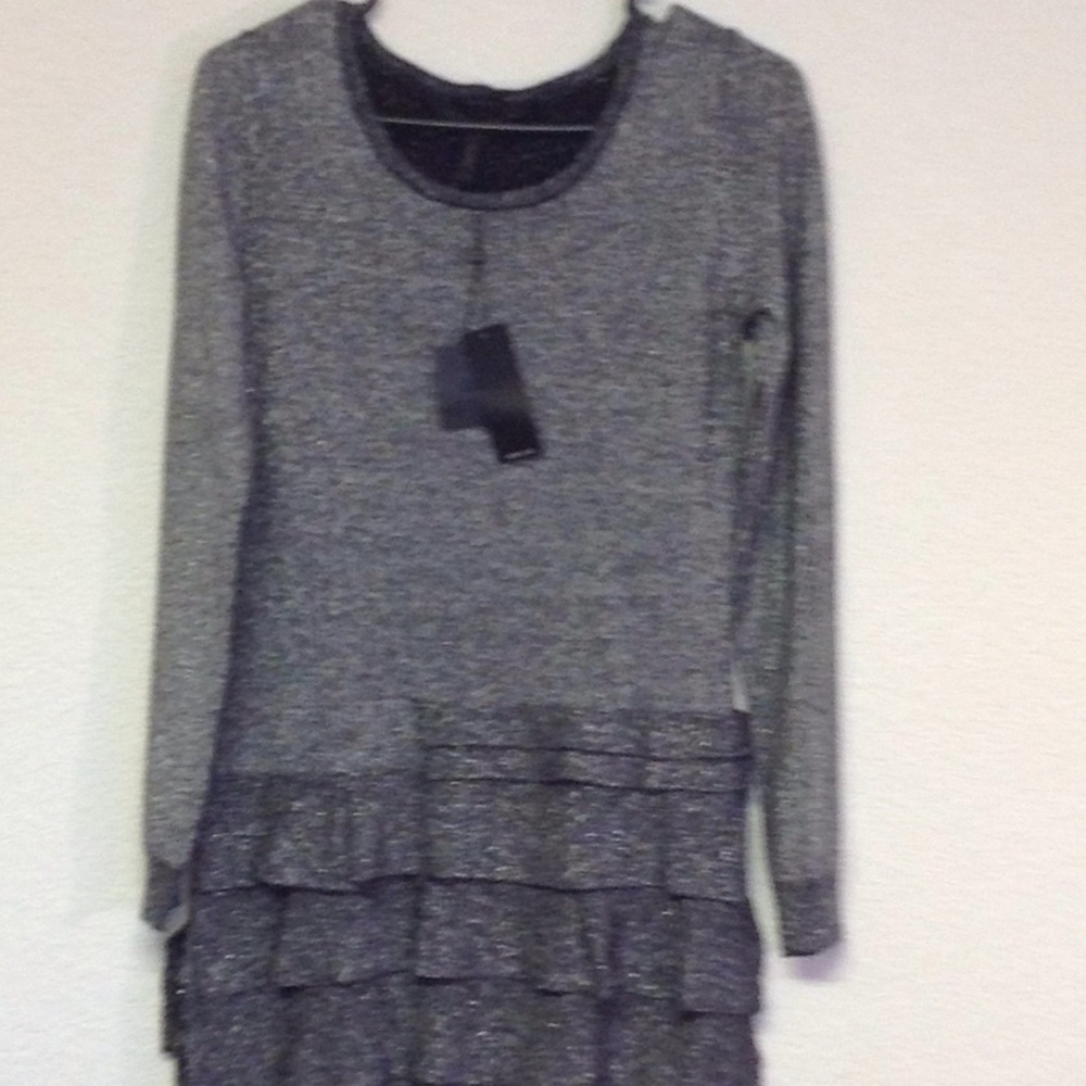 Sparkly silver dress with ruffled bottom.